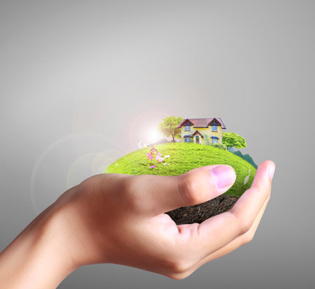 Business man house in human hands の写真素材