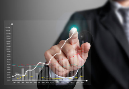 business man pointing at growth graph and business conceptの写真素材
