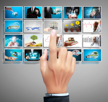 Businessman touch screen to choose digital photos