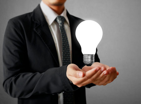 idea concept, man holding light bulbの写真素材