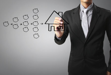 Businessman drawing a houseの写真素材