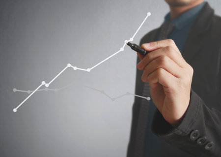 Businessman drawing graphics a growing graphの写真素材