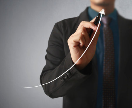 Businessman drawing graphics a growing graphの写真素材