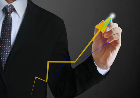 Businessman drawing graphics a growing graphの写真素材