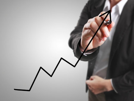 Businessman drawing graphics a growing graphの写真素材