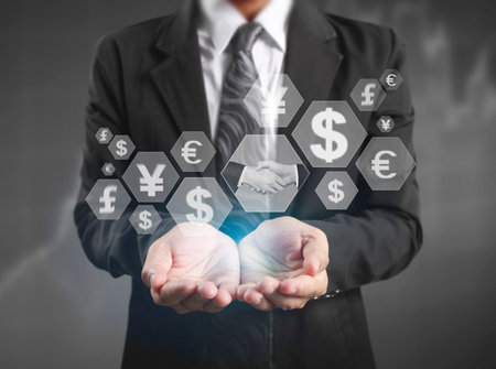 businessman with financial symbols coming from handの写真素材