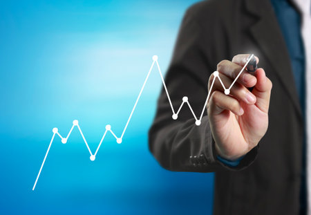 Businessman drawing graphics a growing graphの写真素材