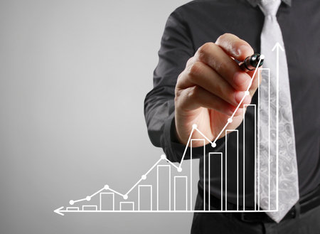 Businessman drawing graphics a growing graphの写真素材
