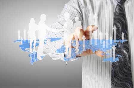 businessman with financial symbols coming from handの写真素材