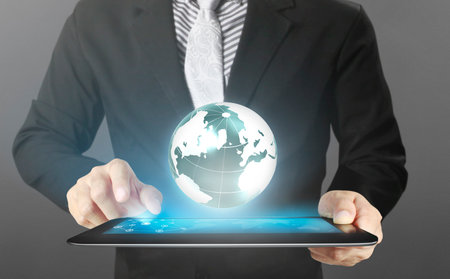 multitasking man using tablet in a handの写真素材