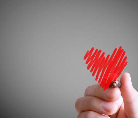 Hand drawing a heart with markerの写真素材