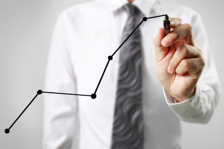 Businessman drawing graphics a growing graphの写真素材