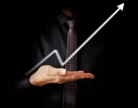 Businessman with financial symbols comingの写真素材