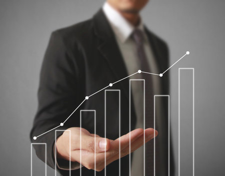 Businessman with financial symbols comingの写真素材