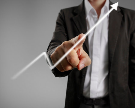 Businessman with financial symbols comingの写真素材