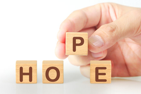 Concept creative idea and innovation. wooden cube block  in hand with symbolの写真素材