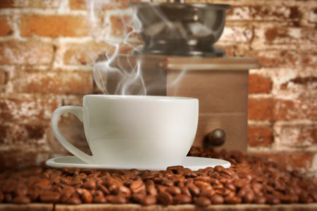 Coffee cup and coffee beans on a wood tableの写真素材