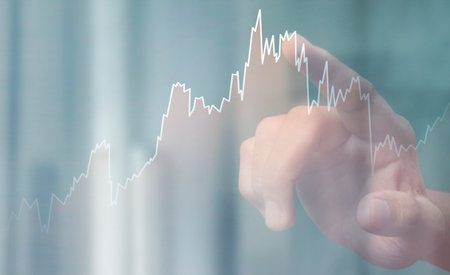 Hand touching a graphs of financial indicator and accounting market economy analysis chart