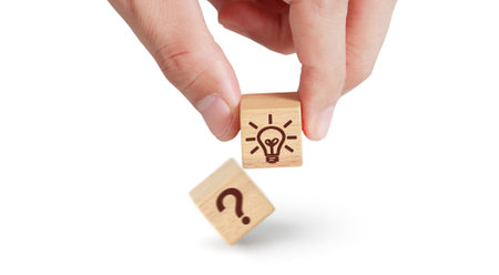 Wooden cube block in hand with symbol