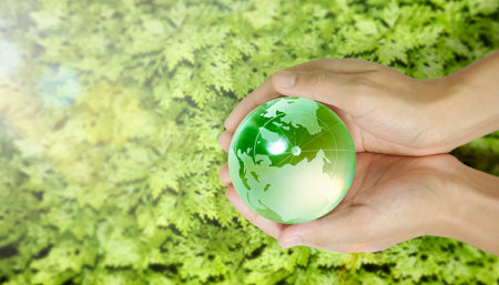 Globe, earth in human hand, holding our planet glowing.