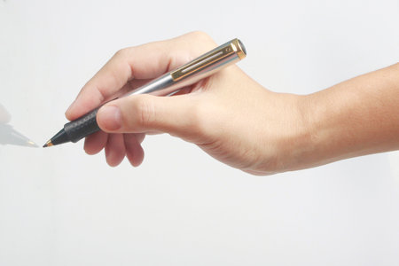 Hand with pen on a white backgroundの写真素材