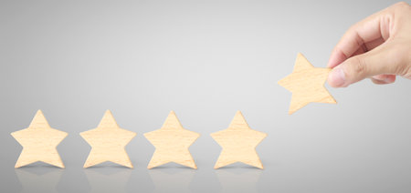 Hand of putting increase wood five star shape.The best excellent business services rating customer...