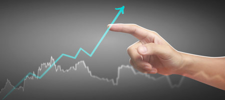 Hand touching a graphs of financial indicator and accounting market economy analysis chartの写真素材