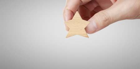 Hand of putting increase wood five star shape.The best excellent business services rating customer...
