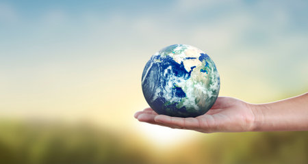 Glass globe in hand, Energy saving conceptの写真素材