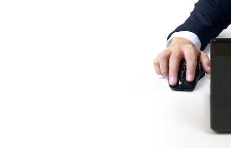 Hand holding computer mouse on whiteの写真素材