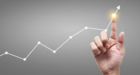 Hand touching a graphs of financial indicator and accounting market economy analysis chartの写真素材