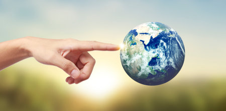 Globe earth in human hand, holding our planet glowing.の写真素材