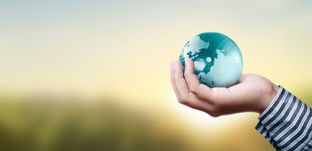 Globe ,earth in human hand, holding our planet glowing.の写真素材