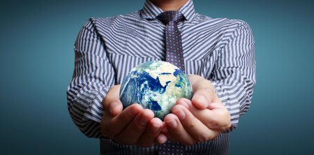 Globe ,earth in human hand, holding our planet glowing.の写真素材