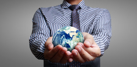 Globe earth in human hand, holding our planet glowing.の写真素材