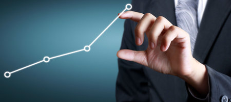 Hand touching a graphs of financial indicator and accounting market economy analysis chartの写真素材