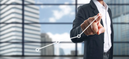 Hand touching a graphs of financial indicator and accounting market economy analysis chartの写真素材