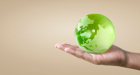 Globe  earth in human hand, holding our planet glowing.