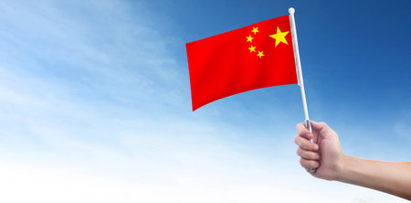 Hand holding Chinese flag.の写真素材