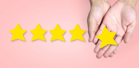 Hand of putting increase five a star shape.The best excellent business services rating customer...