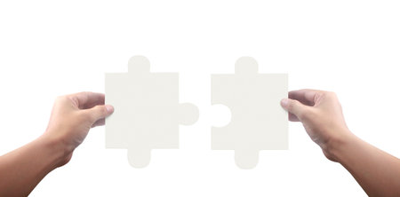 Hand of connecting jigsaw puzzle,Concept of teamwork. isolatedの写真素材