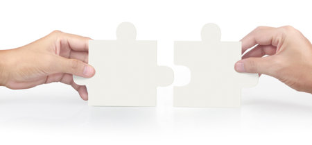 Hand of connecting jigsaw puzzle,Concept of teamwork. isolatedの写真素材