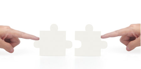 Hand of connecting jigsaw puzzle,Concept of teamwork. isolatedの写真素材