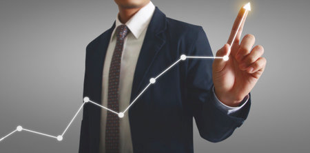 Hand touching a graphs of financial indicator and accounting market economy analysis chartの写真素材