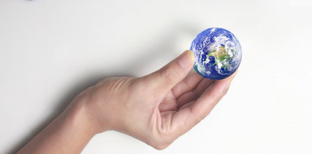 Globe ,earth in human hand, holding our planet glowing.の写真素材