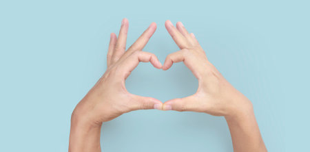 Hands making sign Heart isolated. Beautiful hands  with copy space. Love concept on Valentine day