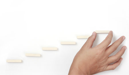 Block stacking as step stair in hand. Business concept for growth success processの写真素材