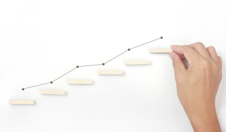 Block stacking as step stair in hand. Business concept for growth success processの写真素材