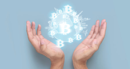 Hands showing bitcoin icon as virtual money on digitalの写真素材