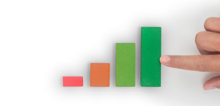 Business connecting piece of multi colored pie wood chart in a hand